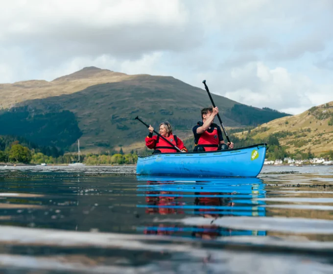 Guests canoeing on the loch at an Argyll Holidays park